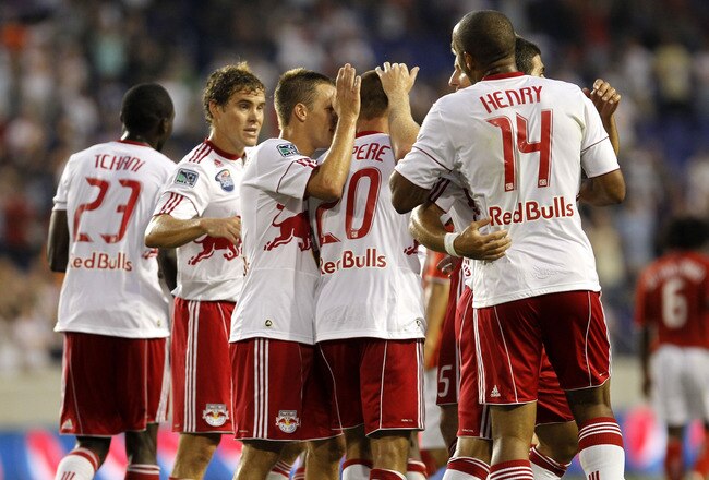HARRISON, NJ - AUGUST 11: Joel Lindpere of the New York Red Bulls is congratulated by his teammates on his goal against the Toronto FC at Red Bull Arena on August 11, 2010 in Harrison, New Jersey.  (Photo by Chris Trotman/Getty Images)