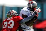 TAMPA - JULY 31:  Receiver Mario Urrutia #89 of the Tampa Bay Buccaneers catches a pass in front of defender Elbert Mack #33 during training camp at One Buccaneer Place on July 31, 2010 in Tampa, Florida.  (Photo by J. Meric/Getty Images)