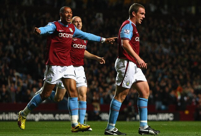 BIRMINGHAM, ENGLAND - OCTOBER 05:  Richard Dunne (R) of Aston Villa walks away after scoring the opening goal during the Barclays Premier League match between Aston Villa and Manchester City at Villa Park on October 5, 2009 in Birmingham, England.  (Photo by Clive Rose/Getty Images)