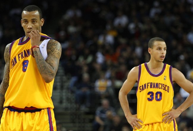 OAKLAND, CA - DECEMBER 03:  Stephen Curry #30 and Monta Ellis #8 of the Golden State Warriors look on near the end of the game against the Houston Rockets during an NBA game at Oracle Arena on December 3, 2009 in Oakland, California. NOTE TO USER: User expressly acknowledges and agrees that, by downloading and/or using this Photograph, user is consenting to the terms and conditions of the Getty Images License Agreement.  (Photo by Jed Jacobsohn/Getty Images)