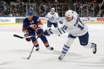 UNIONDALE, NY - MARCH 14:  Tomas Kaberle #15 of the Toronto Maple Leafs shoots the puck against Kyle Okposo #21 of the New York Islanders on March 14, 2010 at Nassau Coliseum in Uniondale, New York. The Isles defeated the Leafs 4-1.  (Photo by Jim McIsaac/Getty Images)