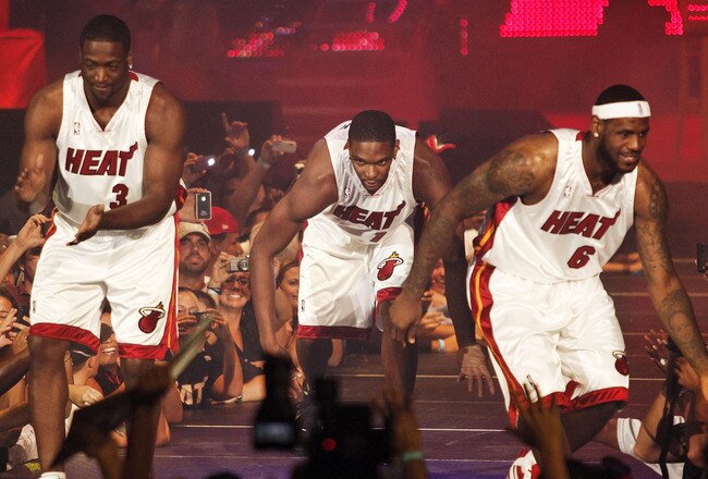 MIAMI - JULY 09:  Fans cheer as (L-R) Dwyane Wade #3, Chris Bosh #1 and LeBron James #6 of the Miami Heat are introduced during a welcome party at American Airlines Arena on July 9, 2010 in Miami, Florida.  (Photo by Marc Serota/Getty Images)