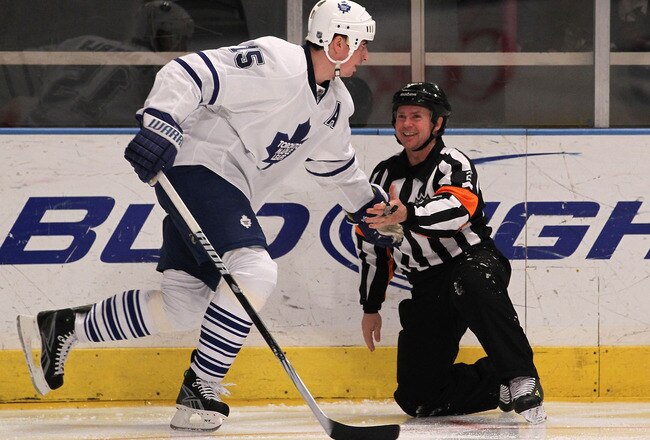 NEW YORK - APRIL 07: Tomas Kaberle #15 of the Toronto Maple Leafs lends a hand to referee Kerry Fraser in his game against the New York Rangers at Madison Square Garden on April 7, 2010 in New York, New York. The Rangers defeated the Maple Leafs 5-1. (Photo by Bruce Bennett/Getty Images)