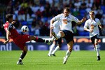 BOLTON, ENGLAND - AUGUST 14: Johan Elmander of Bolton battles for the ball with Aaron Hughes of Fulham  during the Barclays Premier League match between Bolton Wanderers and Fulham at Reebok Stadium on August 14, 2010 in Bolton, England.  (Photo by Laurence Griffiths/Getty Images)