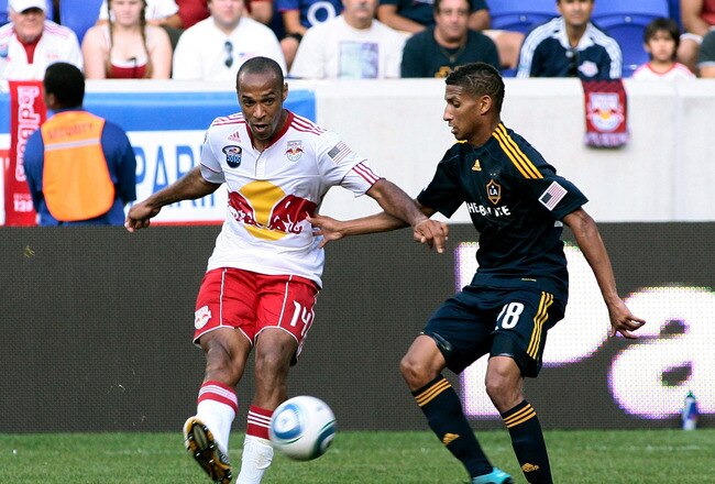 HARRISON, NJ - AUGUST 14: Thierry Henry #14 of the New York Red Bulls plays the ball while being defended by Sean Franklin #28 of the Los Angeles Galaxy during their game at Red Bull Arena on August 14, 2010 in Harrison, New Jersey. (Photo by Andy Marlin/Getty Images )