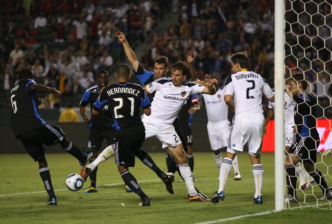 CARSON, CA - JULY 22:  Alan Gordon #21 of the Los Angeles Galaxy vies for the ball with Ike Opara #6 of the San Jose Earthquakes in the second half during their MLS match at The Home Depot Center on July 22, 2010 in Carson, California. Donovan scored on the rebound to tie the game 2-2. The Earthquakes and the Galaxy played to a 2-2 draw.  (Photo by Victor Decolongon/Getty Images)