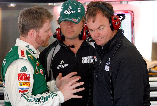 SONOMA, CA - JUNE 18:  Dale Earnhardt Jr., driver of the #88 AMP Energy Chevrolet, talks with his crew chief Lance McGrew in the garage during practice for the NASCAR Sprint Cup Series Toyota/Save Mart 350 at the Infineon Raceway on June 18, 2010 in Sonoma, California.  (Photo by Tom Pennington/Getty Images for NASCAR)