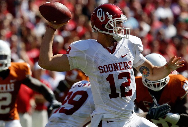 DALLAS - OCTOBER 17:  Quarterback Landry Jones #12 of the Oklahoma Sooners drops back to pass against the Texas Longhorns at Cotton Bowl on October 17, 2009 in Dallas, Texas.  (Photo by Ronald Martinez/Getty Images)