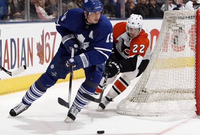 TORONTO - APRIL 6: Tomas Kaberle #15 of the Toronto Maple Leafs gets away from Ville Leino #22 of the Philadelphia Flyers during an NHL game at the Air Canada Centre April 6, 2010 in Toronto, Ontario, Canada. (Photo by Abelimages/Getty Images)