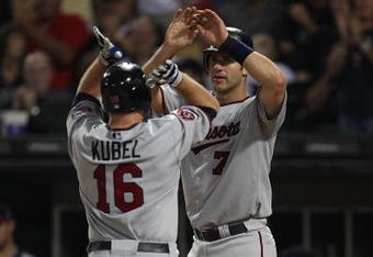 CHICAGO - AUGUST 10: Jason Kubel #16 of the Minnesota Twins is greeted at the plate by teammate Joe Mauer #7 after hitting a two-run home run in the 8th inning against the Chicago White Sox at U.S. Cellular Field on August 10, 2010 in Chicago, Illinois. The Twins defeated the White Sox 12-6. (Photo by Jonathan Daniel/Getty Images)