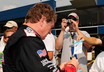 BROOKLYN, MI - AUGUST 13: Bill Elliott, driver of the #21 Motorcraft Ford, signs autographs fans during qualifying for the NASCAR Sprint Cup Series CARFAX 400 at Michigan International Speedway on August 13, 2010 in Brooklyn, Michigan.  (Photo by Rusty Jarrett/Getty Images for NASCAR)
