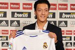 MADRID, SPAIN - AUGUST 18:  New signing Mesut Ozil poses with a Real Madrid shirt during his presentation as new Real Madrid player at the Estadio Santiago Bernabeu on August 18, 2010 in Madrid, Spain.  (Photo by Jasper Juinen/Getty Images)