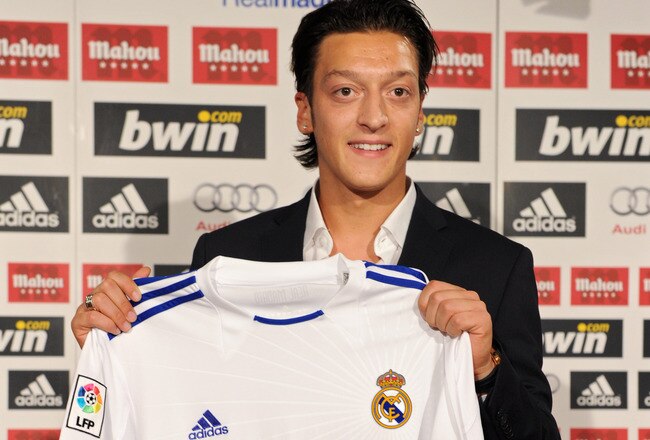 MADRID, SPAIN - AUGUST 18:  New signing Mesut Ozil poses with a Real Madrid shirt during his presentation as new Real Madrid player at the Estadio Santiago Bernabeu on August 18, 2010 in Madrid, Spain.  (Photo by Jasper Juinen/Getty Images)