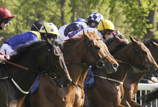 WINDSOR, ENGLAND - MAY 03: Hollow Green and Cathy Gannon (yellow cap, centre) break from the stalls to win The garrison Savannah Classic Handicap Stakes  at Windsor racecourse on May 03, 2010 in Windsor, England  (Photo by Alan Crowhurst/ Getty Images)