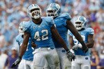 CHAPEL HILL, NC - SEPTEMBER 19:  Robert Quinn #42 of the North Carolina Tar Heels celebrates after a sack with teammate Marvin Austin #9 against the East Carolina Pirates at Kenan Stadium on September 19, 2009 in Chapel Hill, North Carolina.  (Photo by Streeter Lecka/Getty Images)