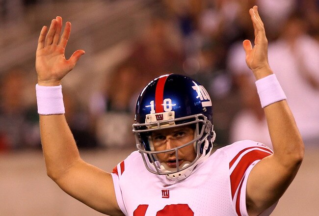 EAST RUTHERFORD, NJ - AUGUST 16:  Eli Manning #10 of the New York Giants celebrates a touchdown in the first quarter during their game against the New York Jets at New Meadowlands Stadium on August 16, 2010 in East Rutherford, New Jersey.  (Photo by Nick Laham/Getty Images)