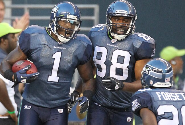 SEATTLE - AUGUST 14:  Wide receiver Mike Williams #1 of the Seattle Seahawks celebrates with Cameron Morrah #88 and Justin Forsett #20 after scoring a touchdown during the preseason game against the Tennessee Titans at Qwest Field on August 14, 2010 in Seattle, Washington. (Photo by Otto Greule Jr/Getty Images)