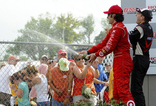 LEXINGTON, OH - AUGUST 08:  Dario Franchitti (L) of Scotland driver of the #10 Target Chip Ganassi Racing Dallara Honda celebrates winning with second place finisher Will Power (R) as they spray fans with champagne during the IZOD IndyCar Series Honda Indy 200 on August 8, 2010 in Lexington, Ohio.  (Photo by Robert Laberge/Getty Images)