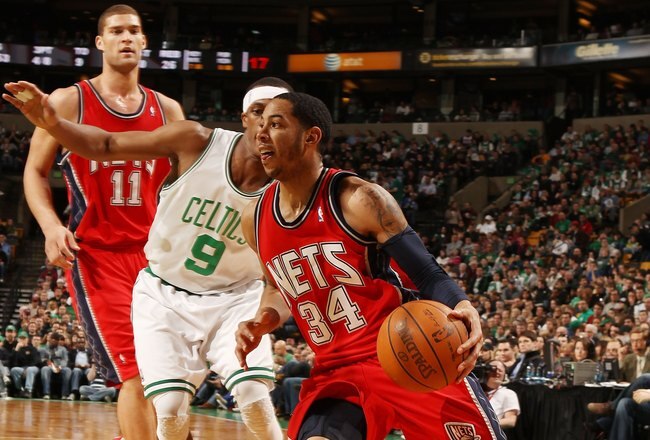 BOSTON - FEBRUARY 27:  Devin Harris #34 of the New Jersey Nets heads for the net as Rajon Rondo #9 of the Boston Celtics defends at the TD Garden on February 27, 2010 in Boston, Massachusetts. The Nets defeated the Celtics 104-96.  NOTE TO USER: User expressly acknowledges and agrees that, by downloading and or using this photograph, User is consenting to the terms and conditions of the Getty Images License Agreement.  (Photo by Elsa/Getty Images)