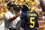 ANN ARBOR, MI - SEPTEMBER 19:  Head coach Rich Rodriguez of the Michigan Wolverines talks with quarterback Tate Forcier #5 during the game with the Eastern Michigan Eagles at Michigan Stadium on September 19, 2009 in Ann Arbor, Michigan.  Michigan won 45-17.  (Photo by Stephen Dunn/Getty Images)