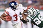 EAST RUTHERFORD, NJ - AUGUST 16:  Victor Cruz #3 of the New York Giants breaks a tackle from Dwight Lowery #26 of the New York Jets during the preseason game at New Meadowlands Stadium on August 16, 2010 in East Rutherford, New Jersey. The  Giants won 31 - 16. (Photo by Andrew Burton/Getty Images)