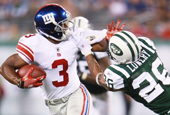 EAST RUTHERFORD, NJ - AUGUST 16:  Victor Cruz #3 of the New York Giants breaks a tackle from Dwight Lowery #26 of the New York Jets during the preseason game at New Meadowlands Stadium on August 16, 2010 in East Rutherford, New Jersey. The  Giants won 31 - 16. (Photo by Andrew Burton/Getty Images)