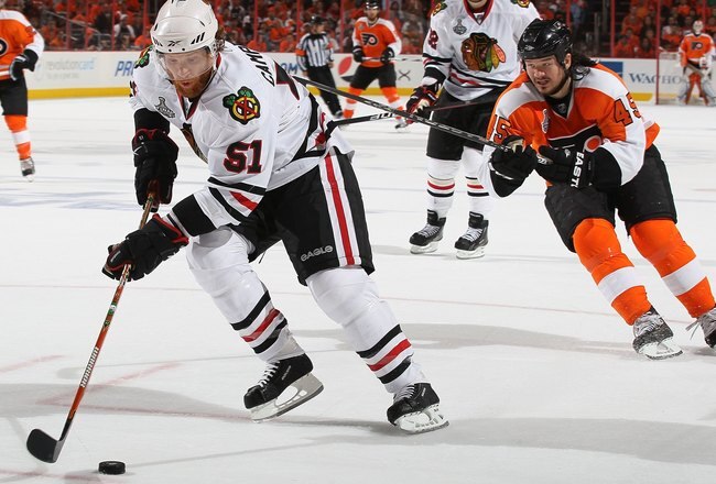 PHILADELPHIA - JUNE 04:  Brian Campbell #51 of the Chicago Blackhawks handles the puck against Arron Asham #45 of the Philadelphia Flyers in Game Four of the 2010 NHL Stanley Cup Final at Wachovia Center on June 4, 2010 in Philadelphia, Pennsylvania.  (Photo by Jim McIsaac/Getty Images)