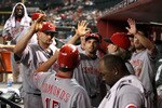 PHOENIX - AUGUST 18:  (L-R) Jonny Gomes #31, Joey Votto #19 and Scott Rolen #27 of the Cincinnati Reds congratulate teammate Jim Edmonds #15 after he scored a run against the Arizona Diamondbacks during the ninth inning of the Major League Baseball game at Chase Field on August 18, 2010 in Phoenix, Arizona.  (Photo by Christian Petersen/Getty Images)