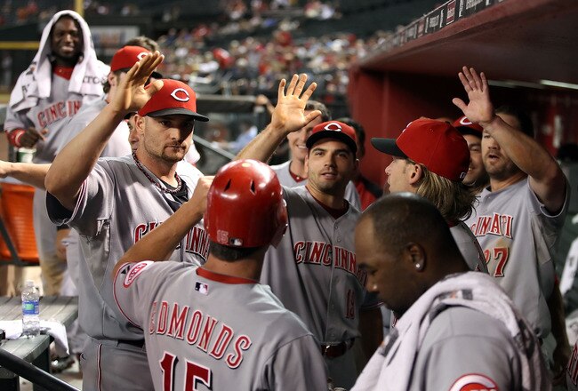 PHOENIX - AUGUST 18:  (L-R) Jonny Gomes #31, Joey Votto #19 and Scott Rolen #27 of the Cincinnati Reds congratulate teammate Jim Edmonds #15 after he scored a run against the Arizona Diamondbacks during the ninth inning of the Major League Baseball game at Chase Field on August 18, 2010 in Phoenix, Arizona.  (Photo by Christian Petersen/Getty Images)