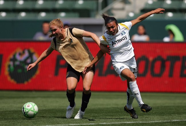 CARSON, CA - APRIL 19:  Rachel Buehler #4 of FC Gold Pride battles for possession against Marta #10 of the Los Angeles Sol during the WPS match at The Home Depot Center on April 19, 2009 in Carson, California. (Photo by Victor Decolongon/Getty Images)