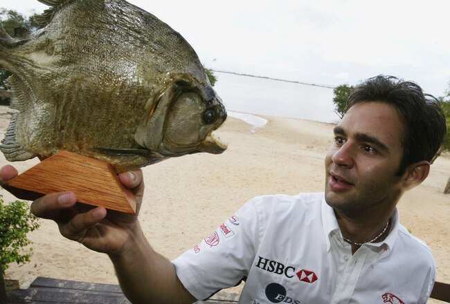 MANAUS - APRIL 1:  Antonio Pizzonia of Brazil and Jaguar  re-visits his home town and comes face to face with a Pirahna fish in Manaus before the Brazilian Grand Prix on April 1, 2003 in Manaus, Brazil. (Photo by Clive Rose/Getty Images).