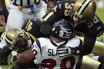 HOUSTON - AUGUST 22:  Running back Steve Slaton #20 of the Houston Texans is tackled by Chris Reis #39, Tracy Porter #22 and Roman Harper #41 of the New Orleans Saints on August 22, 2009 in Houston, Texas.  (Photo by Bob Levey/Getty Images)