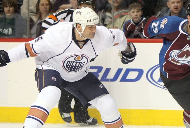 DENVER - JANUARY 18:  Chris Stewart #25 of the Colorado Avalanche controls the puck as Sheldon Souray #44 of the Edmonton Oilers defends during NHL action at the Pepsi Center on January 18, 2010 in Denver, Colorado.  (Photo by Doug Pensinger/Getty Images)