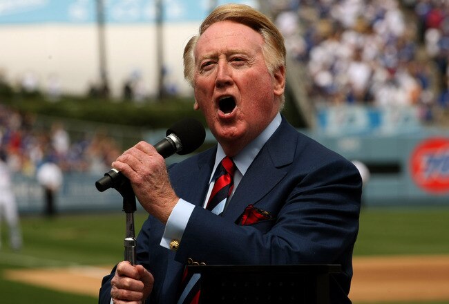 LOS ANGELES - APRIL 13:  Dodgers broadcaster Vin Scully gives the call of 'It's time for Dodger baseball!' during pregame ceremonies for the Los Angeles Dodgers home opener against the San Francisco Giants on April 13, 2009 at Dodger Stadiium in Los Angeles, California. (Photo by Stephen Dunn/Getty Images)
