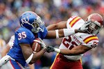 LAWRENCE, KS - OCTOBER 10:  Running back Toben Opurum #35 of the Kansas Jayhawks stiffarms Ter'ran Benton #22 of the Iowa State Cyclones during the game on October 10, 2009 at Memorial Stadium in Lawrence, Kansas.  (Photo by Jamie Squire/Getty Images)