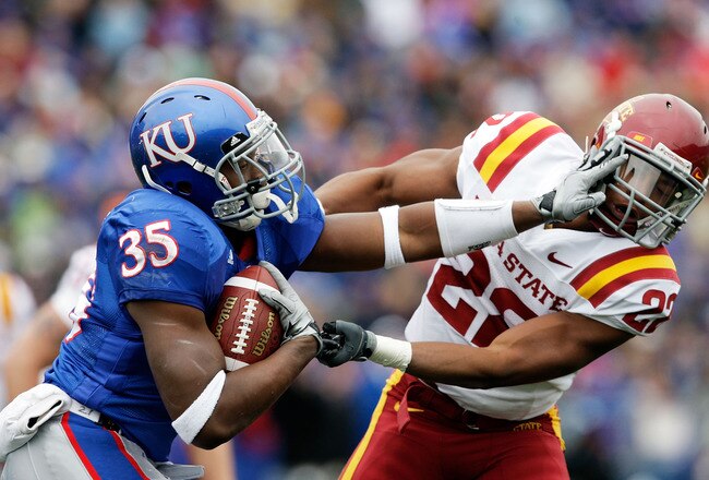 LAWRENCE, KS - OCTOBER 10:  Running back Toben Opurum #35 of the Kansas Jayhawks stiffarms Ter'ran Benton #22 of the Iowa State Cyclones during the game on October 10, 2009 at Memorial Stadium in Lawrence, Kansas.  (Photo by Jamie Squire/Getty Images)