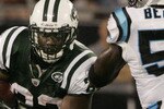 CHARLOTTE,NC - AUGUST 21:  Shonn Greene #23 of the New York Jets runs with the ball as Tony Richardson #49 holds off Jan Beason #52 of the Carolina Panthers during a preseason game at Bank of America Stadium on August 21, 2010 in Charlotte, North Carolina. (Photo by Mary Ann Chastain/Getty Images)