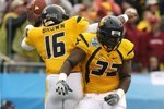 JACKSONVILLE, FL - JANUARY 01:  Running back Ryan Clarke #32 and quarterback Jarrett Brown #16 of the West Virginia Mountaineers celebrate Brown's first quarter touchdown run against the Florida State Seminoles during the Konica Minolta Gator Bowl on January 1, 2010 in Jacksonville, Florida. Florida State defeated West Virginia 33-21 in Bobby Bowden's last game as a head coach for the Seminoles.  (Photo by Doug Benc/Getty Images)