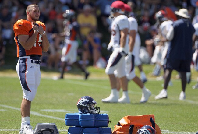 ENGLEWOOD, CO - AUGUST 18:  Rookie quarterback Tim Tebow #15 of the Denver Broncos looks on during training camp practice at Dove Valley on August 18, 2010 in Englewood, Colorado.  (Photo by Doug Pensinger/Getty Images)