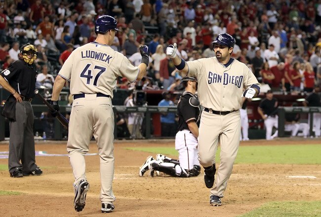 PHOENIX - AUGUST 07:  Adrian Gonzalez #23 of the San Diego Padres celebrates with teammate Ryan Ludwick #47 after Gonzalez hit a solo home run against the Arizona Diamondbacks during the ninth inning of the Major League Baseball game at Chase Field on August 7, 2010 in Phoenix, Arizona.  The Diamondbacks defeated the Padres 6-5. (Photo by Christian Petersen/Getty Images)