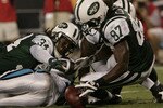 CHARLOTTE,NC- AUGUST 21:  Armanti Edwards #10 of the Carolina Panthers fumbles the ball as David Clowney #87 and Marquice Cole #34 of the New York Jets recover the ball during a preseason game at Bank of America Stadium on August 21, 2010 in Charlotte, North Carolina. (Photo by Mary Ann Chastain/Getty Images)