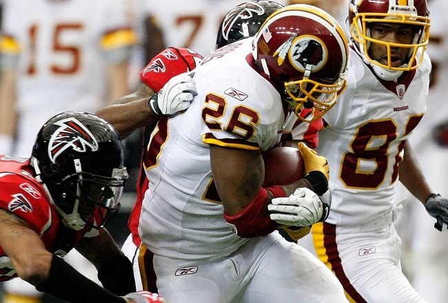 ATLANTA - NOVEMBER 08:  Clinton Portis #26 of the Washington Redskins rushes upfield against Thomas DeCoud #28 of the Atlanta Falcons at Georgia Dome on November 8, 2009 in Atlanta, Georgia.  (Photo by Kevin C. Cox/Getty Images)