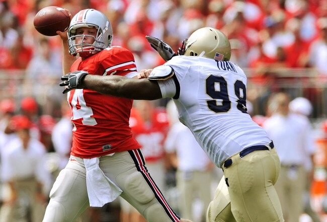 COLUMBUS, OH - SEPTEMBER 05:  Quarterback Joe Bauserman #14 of the Ohio State Buckeyes is forced to throw early as Jabaree Tuani #98 of the Navy Midshipmen pressures him at Ohio Stadium on September 5, 2009 in Columbus, Ohio.  (Photo by Jamie Sabau/Getty Images)