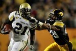 MIAMI GARDENS, FL - JANUARY 05:  Shaun Prater #28 of the Iowa Hawkeyes attempts to tackle Jonathan Dwyer #21 of the Georgia Tech Yellow Jackets during the FedEx Orange Bowl at Land Shark Stadium on January 5, 2010 in Miami Gardens, Florida. Iowa won 24-14. (Photo by Doug Benc/Getty Images)