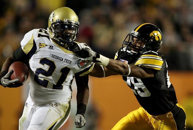MIAMI GARDENS, FL - JANUARY 05:  Shaun Prater #28 of the Iowa Hawkeyes attempts to tackle Jonathan Dwyer #21 of the Georgia Tech Yellow Jackets during the FedEx Orange Bowl at Land Shark Stadium on January 5, 2010 in Miami Gardens, Florida. Iowa won 24-14. (Photo by Doug Benc/Getty Images)