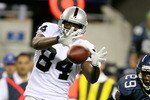 SEATTLE - SEPTEMBER 03:  Wide receiver Javon Walker #84 of the Oakland Raiders makes a catch against Marquis Floyd #29 of the Seattle Seahawks on September 3, 2009 at Qwest Field in Seattle, Washington. (Photo by Otto Greule Jr/Getty Images)