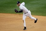 NEW YORK - AUGUST 22:  Derek Jeter #2 of the New York Yankees fields the ball for an out against the Seattle Mariners on August 22, 2010 at Yankee Stadium in the Bronx borough of New York City.  (Photo by Jim McIsaac/Getty Images)