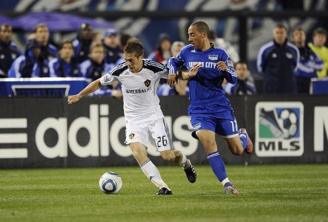 KANSAS CITY, KS - APRIL 24:  Michael Stephens #26 of the Los Angeles Galaxy protects the ball from Ryan Smith #11 of the Kansas City Wizards during their MLS match on April 24, 2010 at Community America Park in Kansas City, Kansas. The Galaxy and Wizards played to a 0-0 draw. (Photo by G.Newman Lowrance/Getty Images)