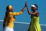 MELBOURNE, AUSTRALIA - JANUARY 29:  Serena and Venus Williams of the United States of America celebrate winning championship point in their Women's doubles final match against Cara Black of Zimbabwe and Liezel Huber of the USA during day twelve of the 2010 Australian Open at Melbourne Park on January 29, 2010 in Melbourne, Australia.  (Photo by Lucas Dawson/Getty Images)