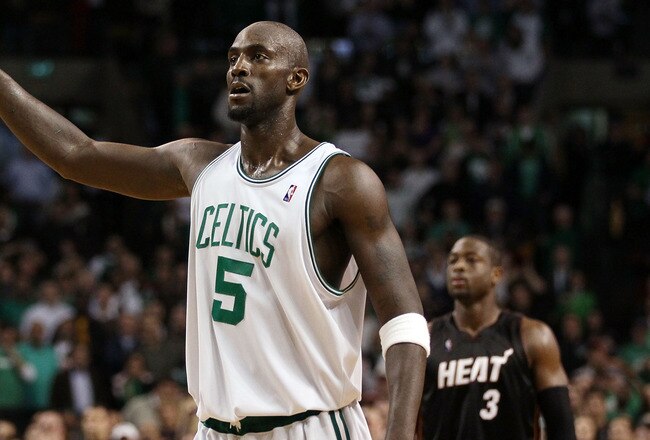 BOSTON - APRIL 27:  Kevin Garnett #5 of the Boston Celtics celebrates at the buzzer as Dwyane Wade #3 of the Miami Heat looks on during Game Five of the Eastern Conference Quarterfinals of the 2010 NBA playoffs at the TD Garden on April 27, 2010 in Boston, Massachusetts. The Celtics defeated the Heat 96-86 to win the series. NOTE TO USER: User expressly acknowledges and agrees that, by downloading and or using this photograph, User is consenting to the terms and conditions of the Getty Images License Agreement.  (Photo by Elsa/Getty Images)